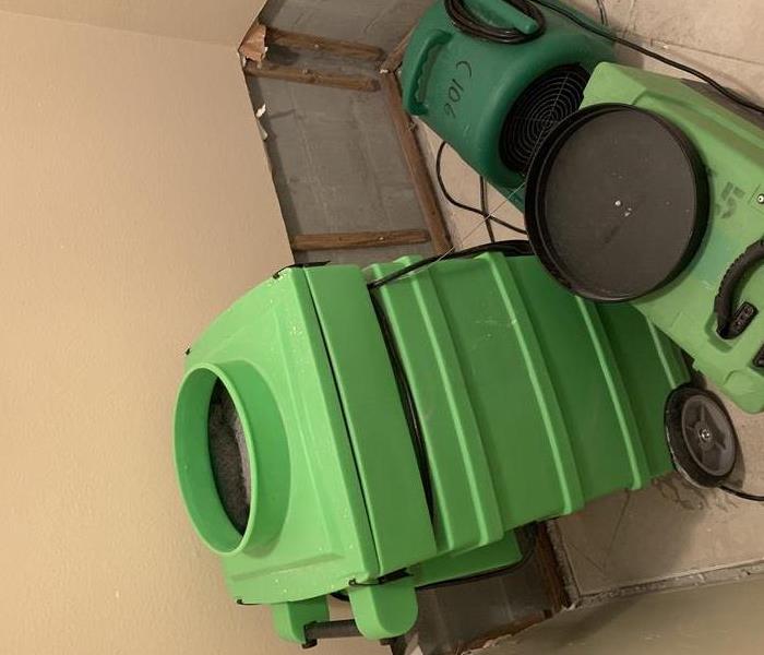 Corner of a room with SERVPRO equipment 
