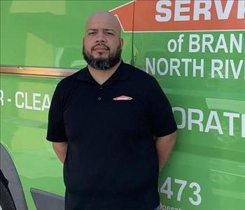 Employee in front of service truck