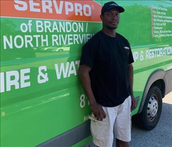 SERVPRO technician standing in front of service truck
