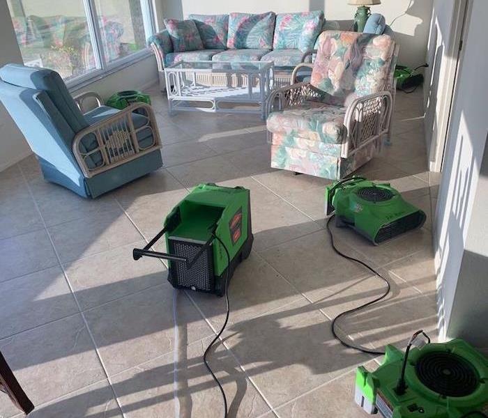 Sunlit living room with SERVPRO drying equipment