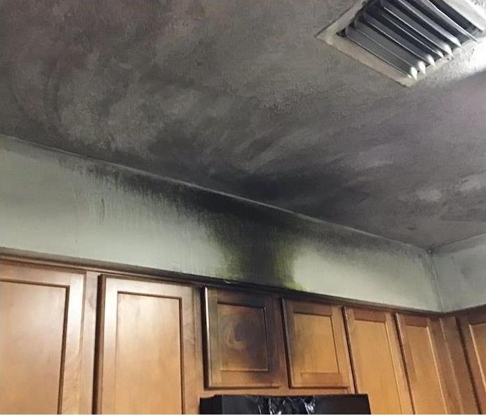 Soot damage on kitchen cabinets and the ceiling