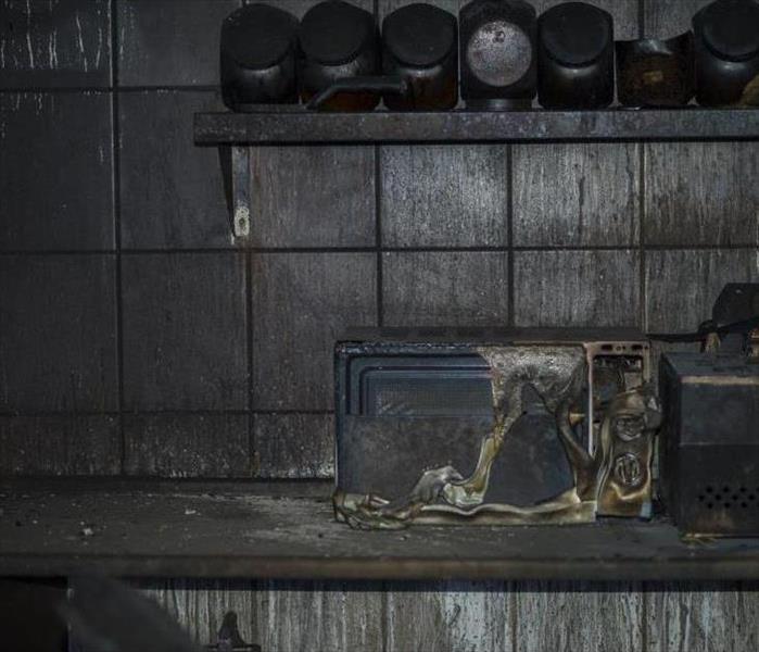 fire damaged kitchen with microwave