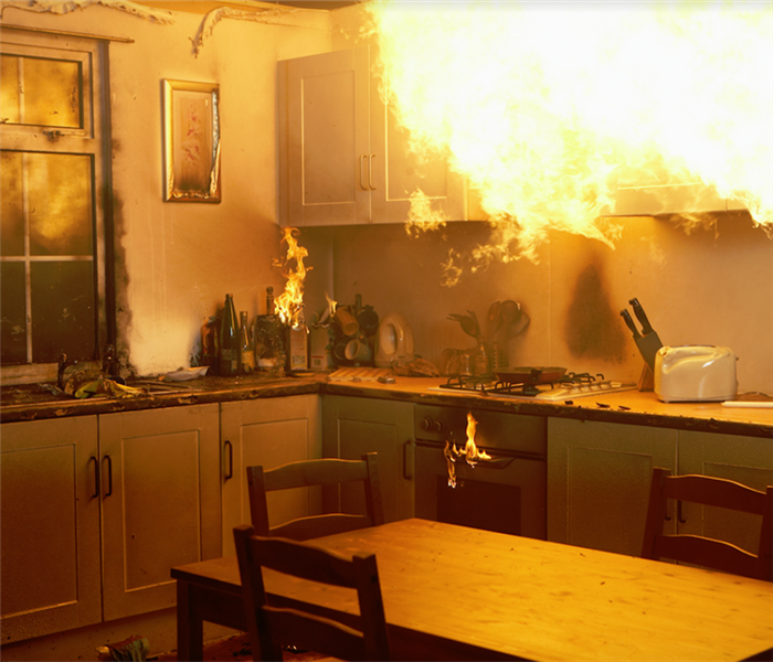 a kitchen with cabinets and appliances on fire