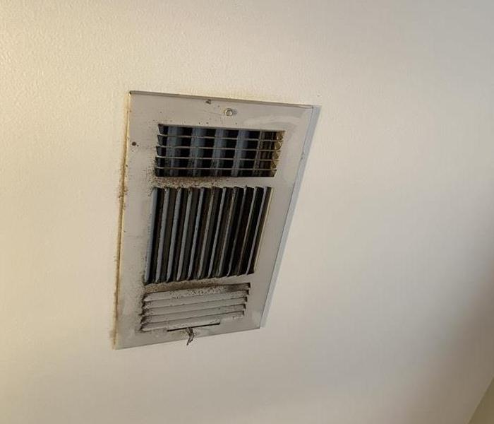 Dirty AC vent that has accumulated dust and needs cleaning