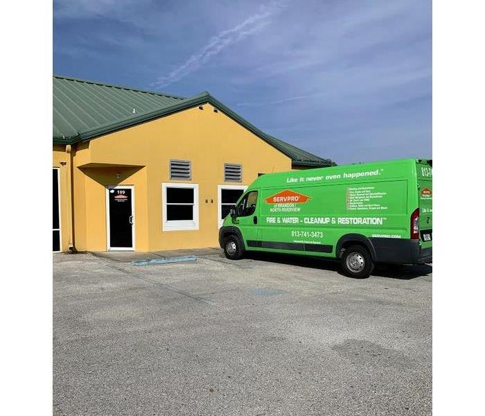 a SERVPRO vehicle in front of a building