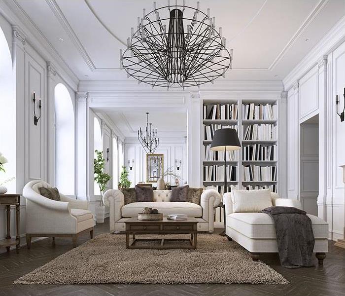 room with white furniture and metal chandeliers