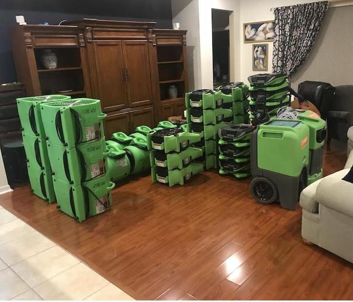 SERVPRO water damage equipment stacked in a living room